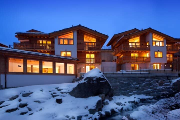 Ski-in/ski-out chalet exterior with private balconies and mountain stream access