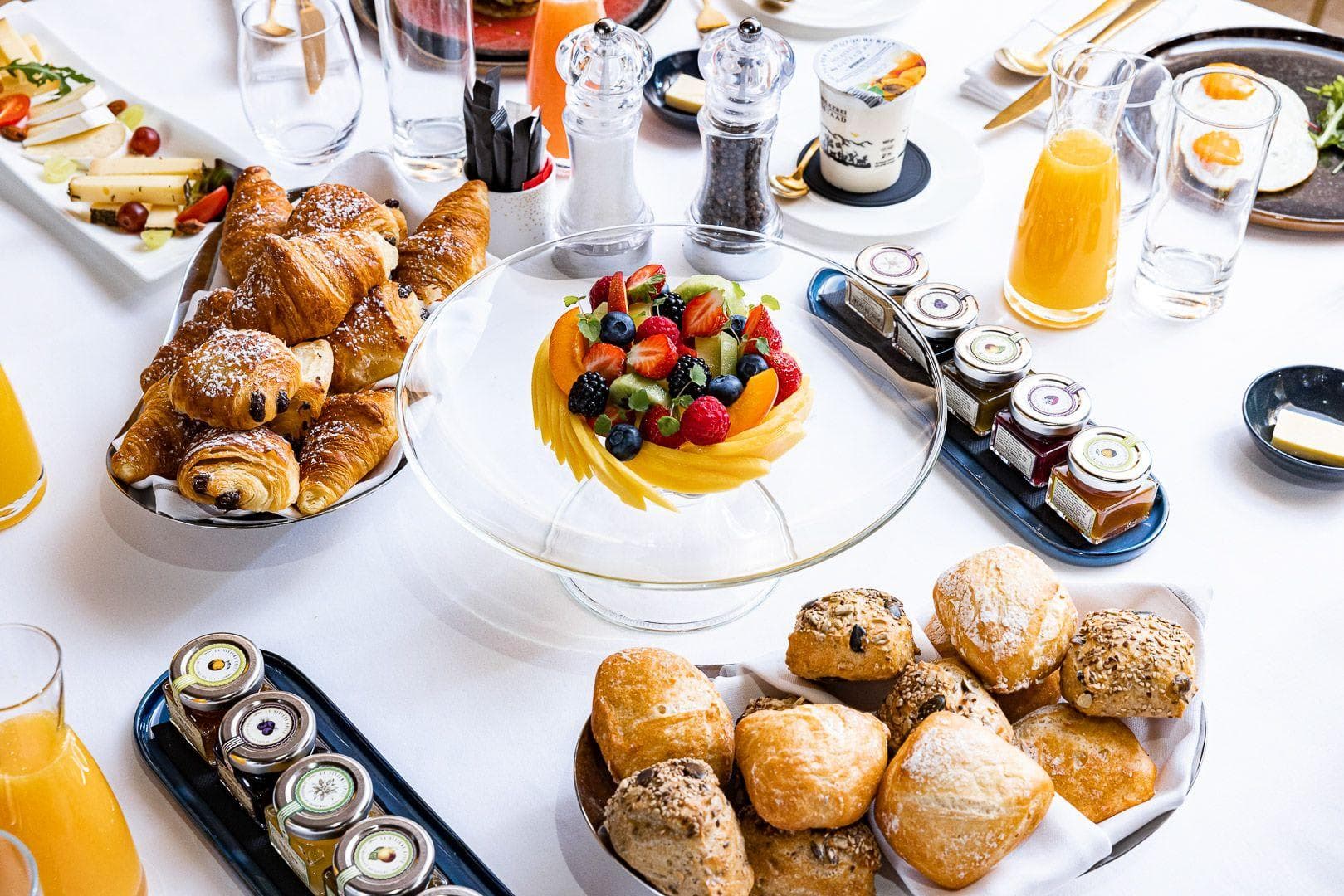 Complimentary continental breakfast spread with fresh pastries, fruit, and local preserves