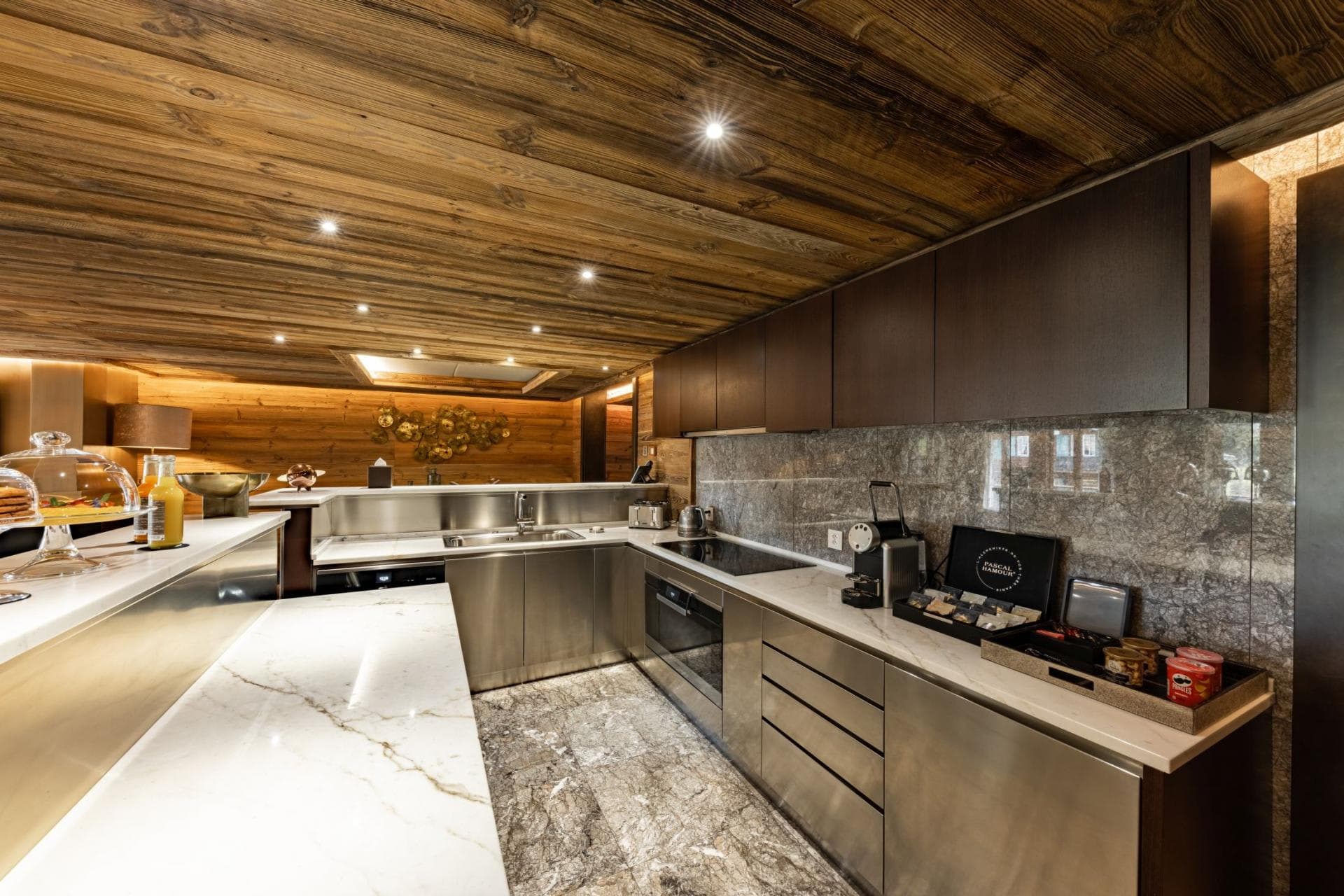 Kitchen with induction cooktop, Nespresso machine, and integrated stainless steel appliances