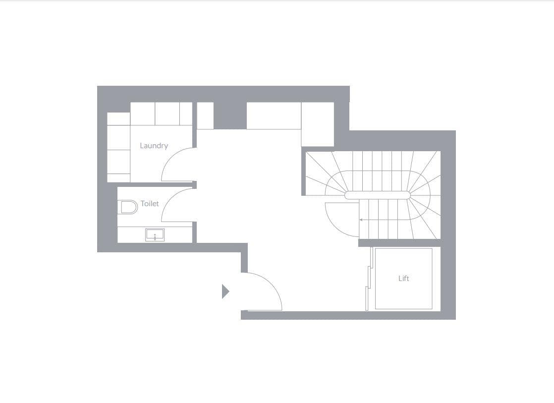 Lower floor plan: laundry, guest toilet, lift, and stair access