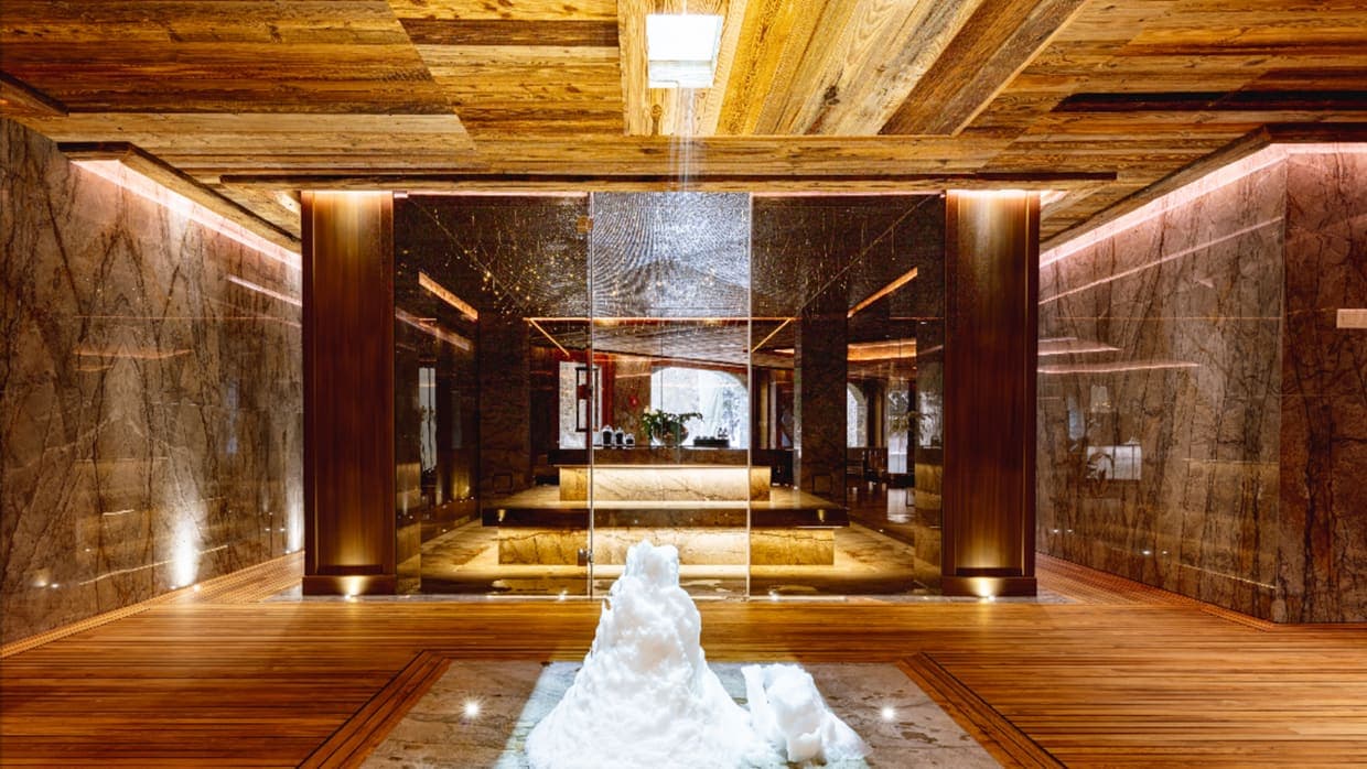 Wellness area with glass-walled sauna and indoor ice fountain
