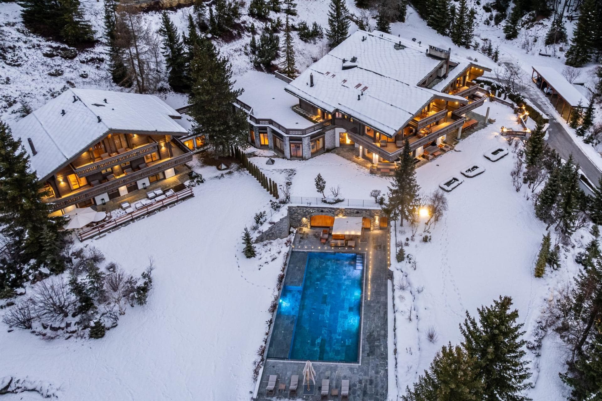 Aerial view of estate featuring heated outdoor pool and two chalets