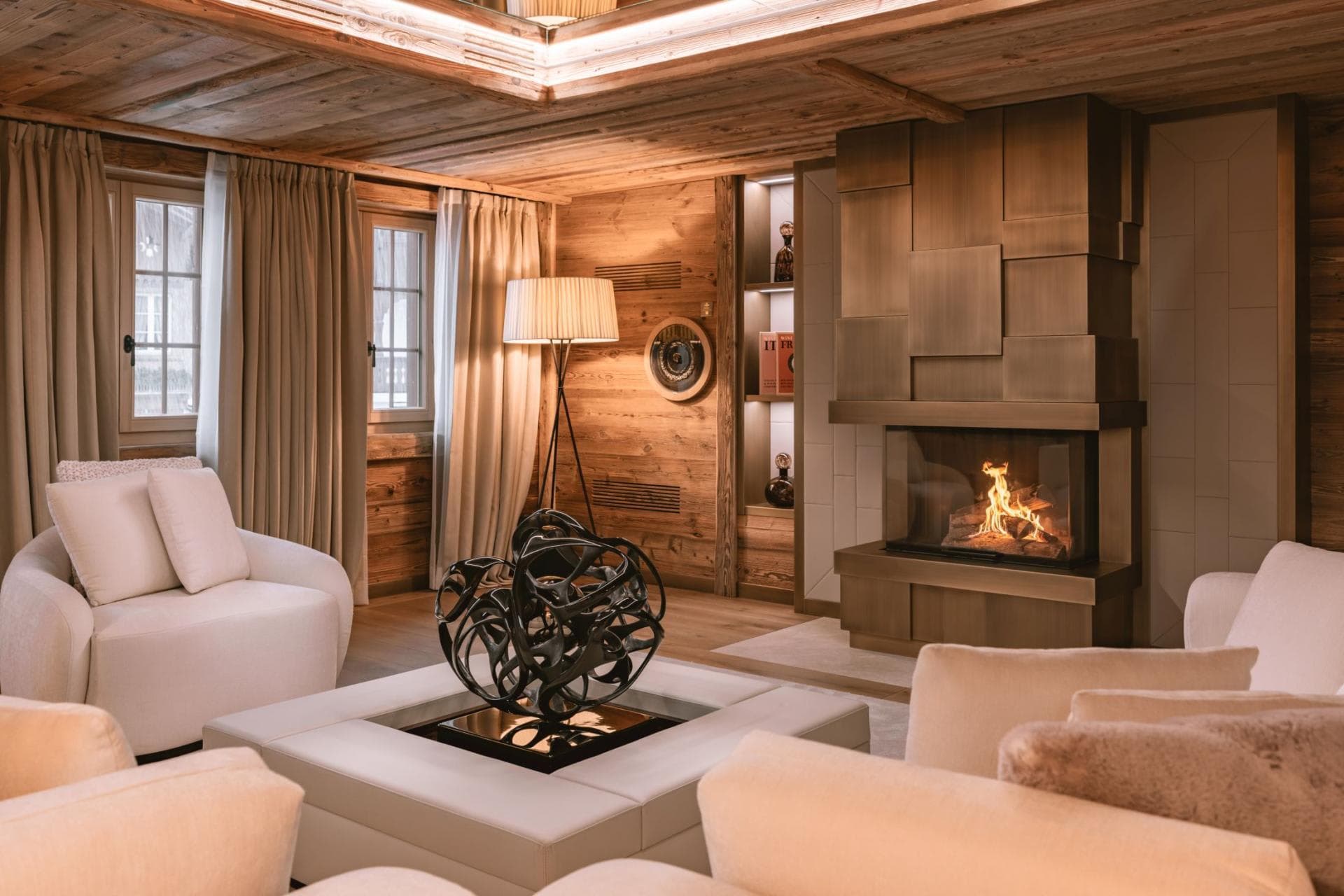 Living room with wood-burning fireplace and timber-paneled walls