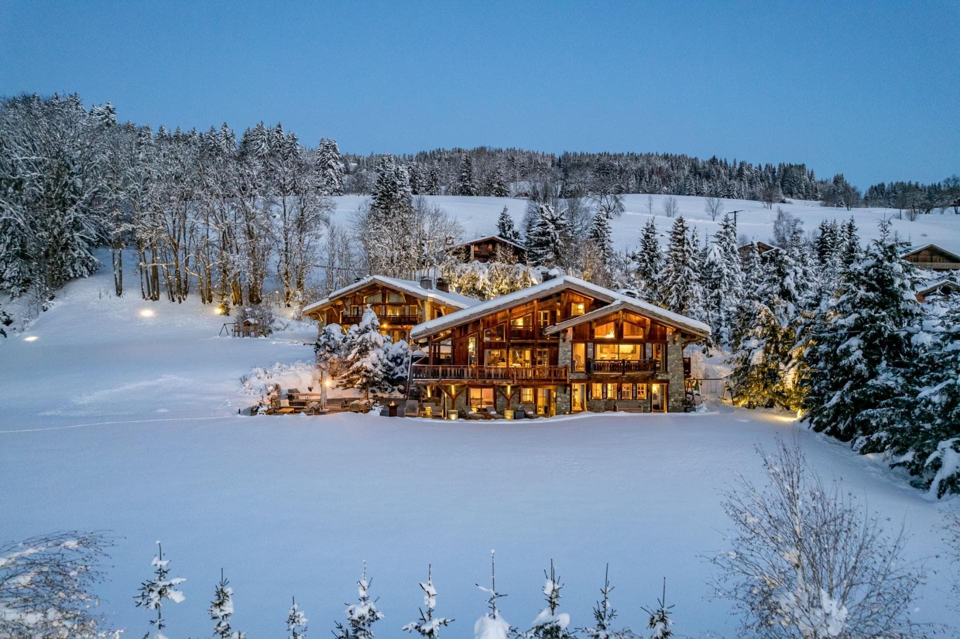 Ski-in/ski-out timber chalets with wraparound balconies and direct piste access