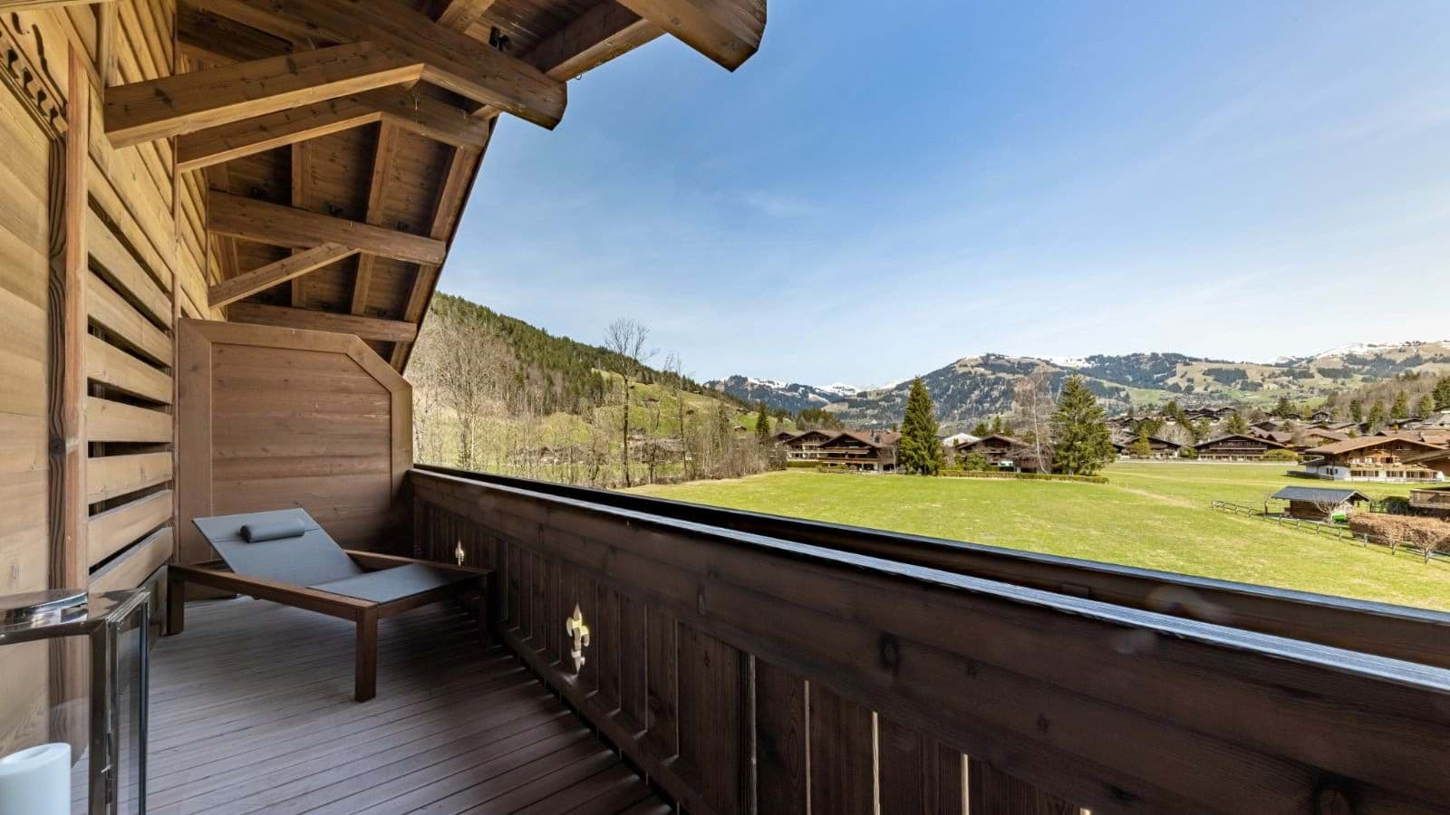 Covered timber balcony with sun lounger and valley views