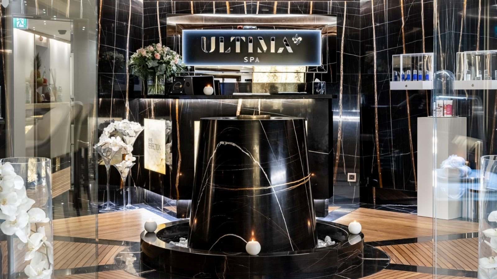 Spa reception with black marble walls and central fountain