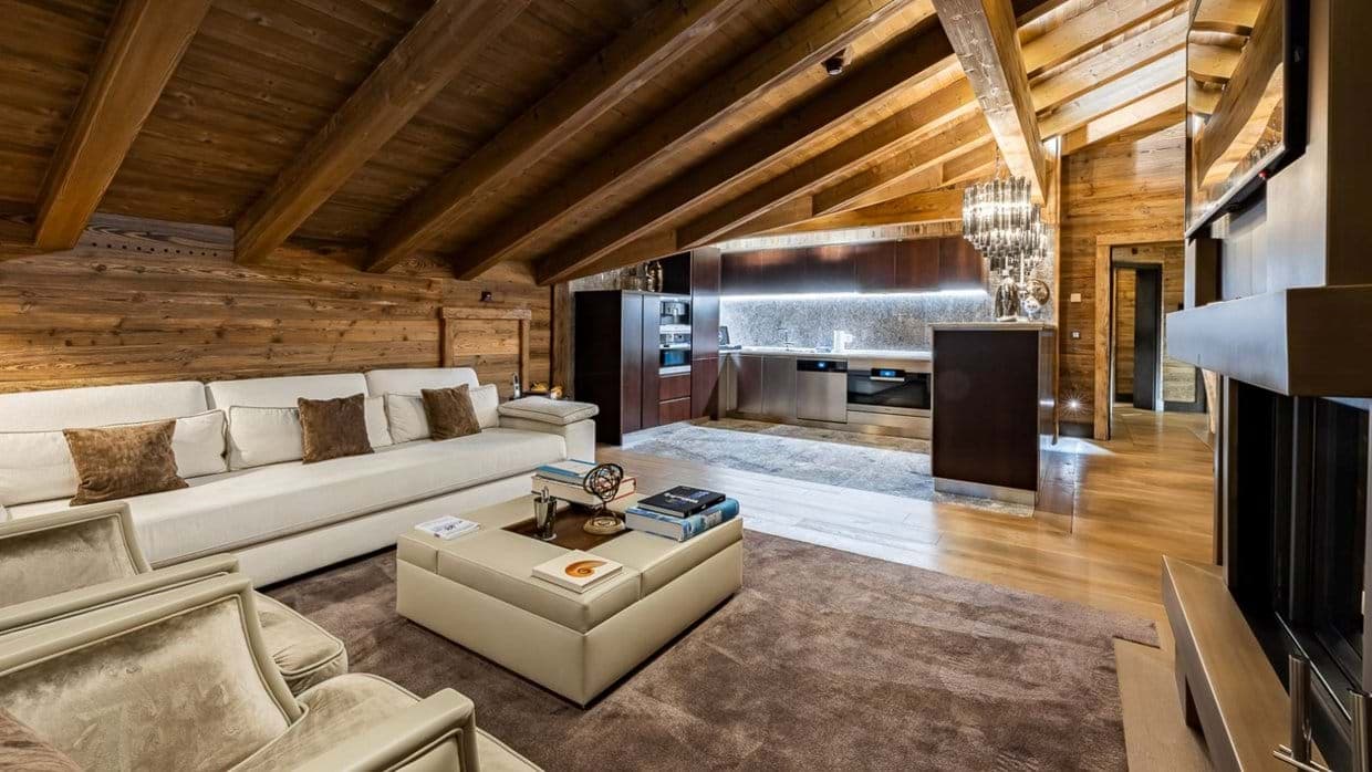 Open-plan living area with vaulted timber ceilings and integrated kitchen