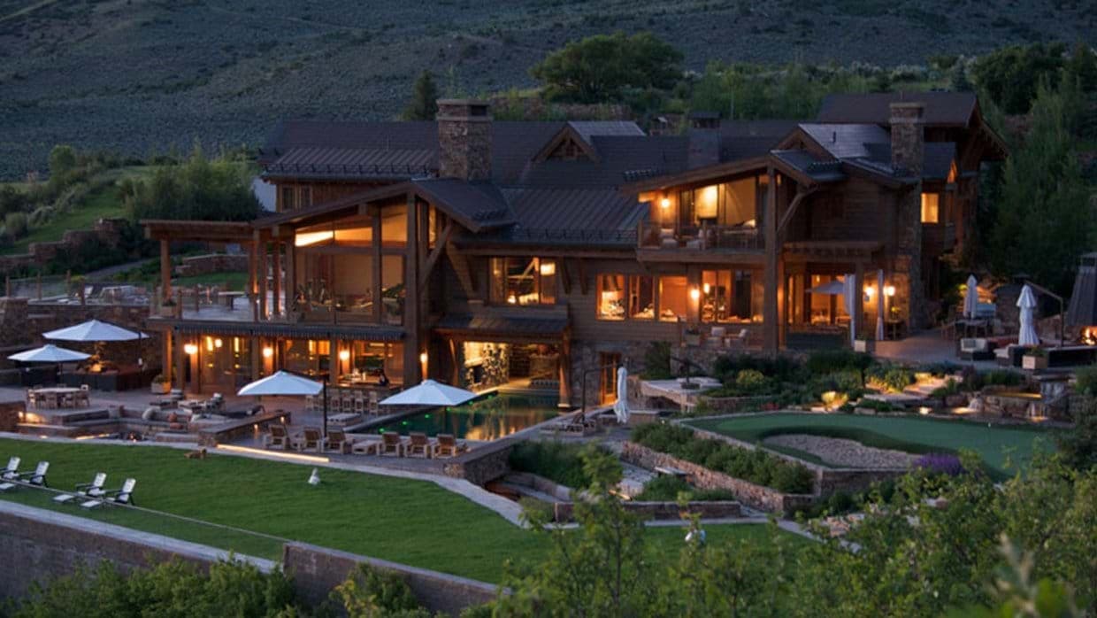 Mountain lodge exterior featuring private putting green and multi-level patio