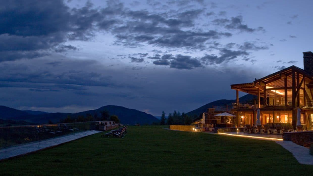 Backyard lawn with mountain views and glass perimeter railing