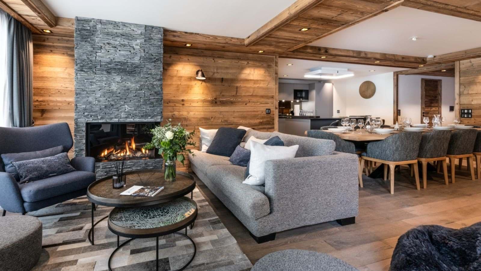 Open-plan living area with stone fireplace and dining table for 10