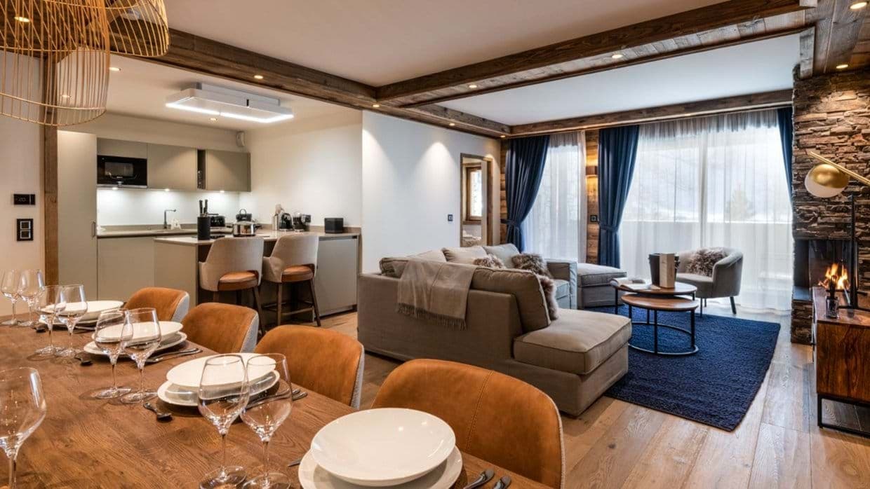 Open-plan living area with wood-burning fireplace and breakfast bar seating