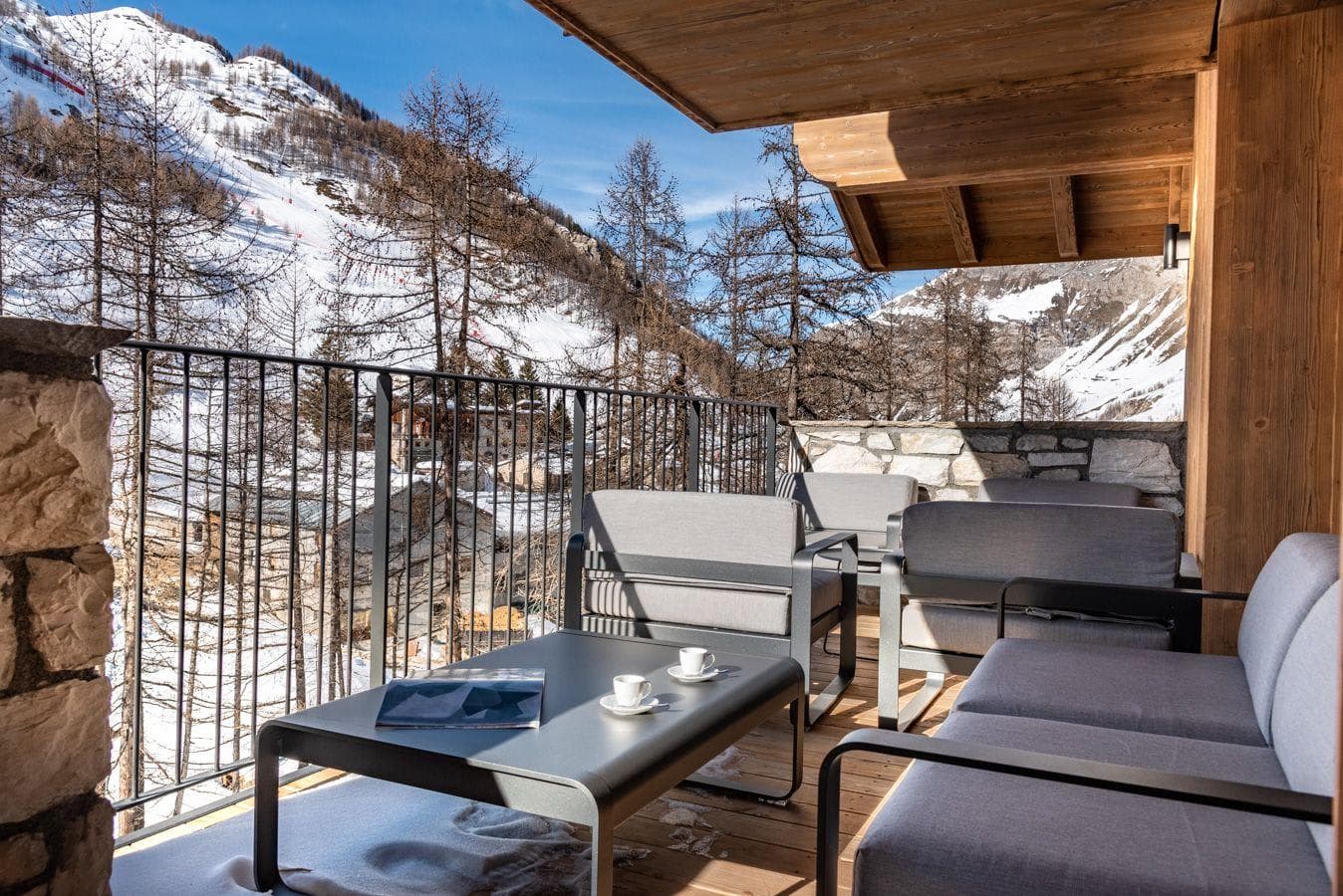 Covered balcony with lounge seating for four; mountain views