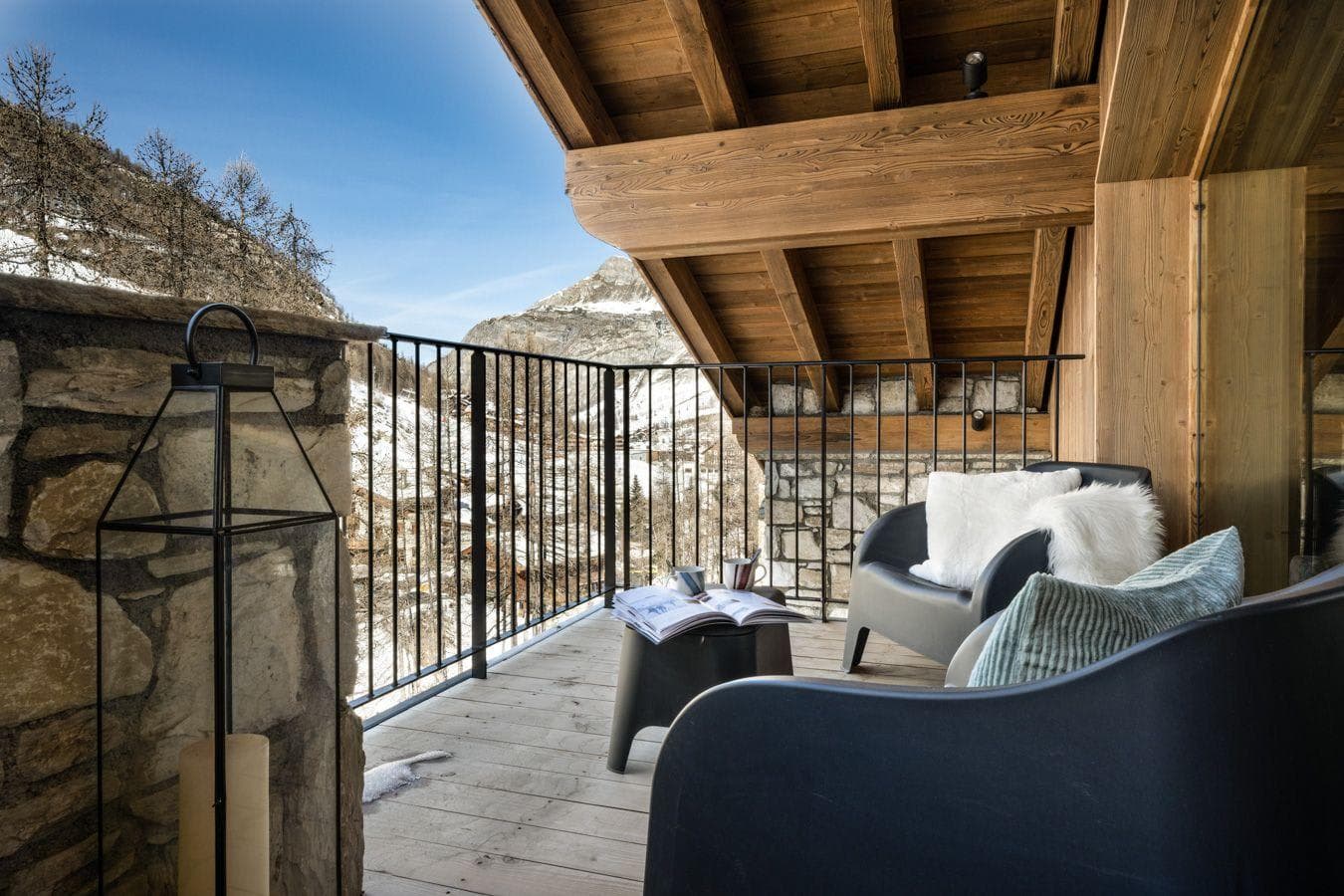 Covered private balcony with mountain views and lounge seating