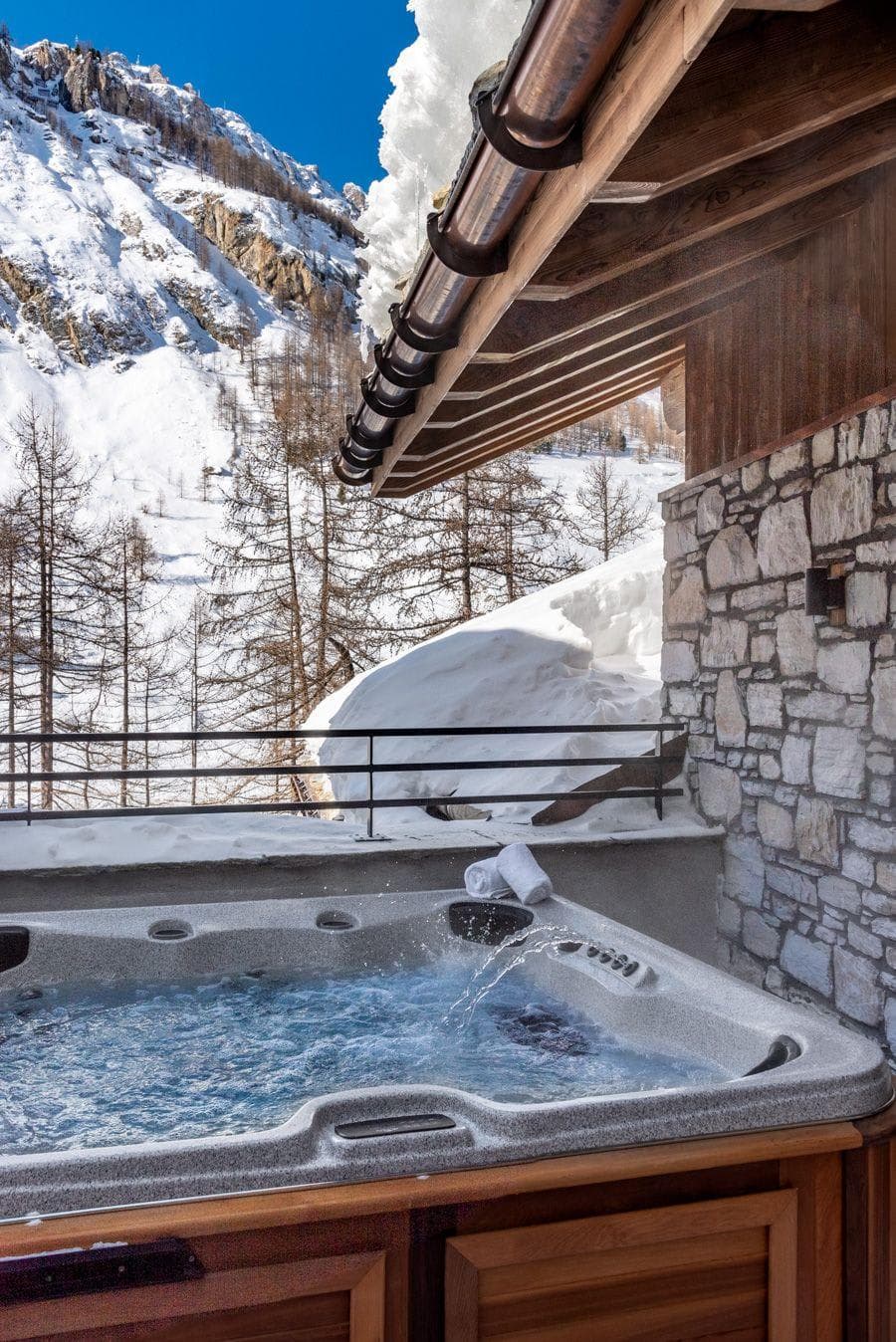Covered outdoor hot tub with mountain and forest views