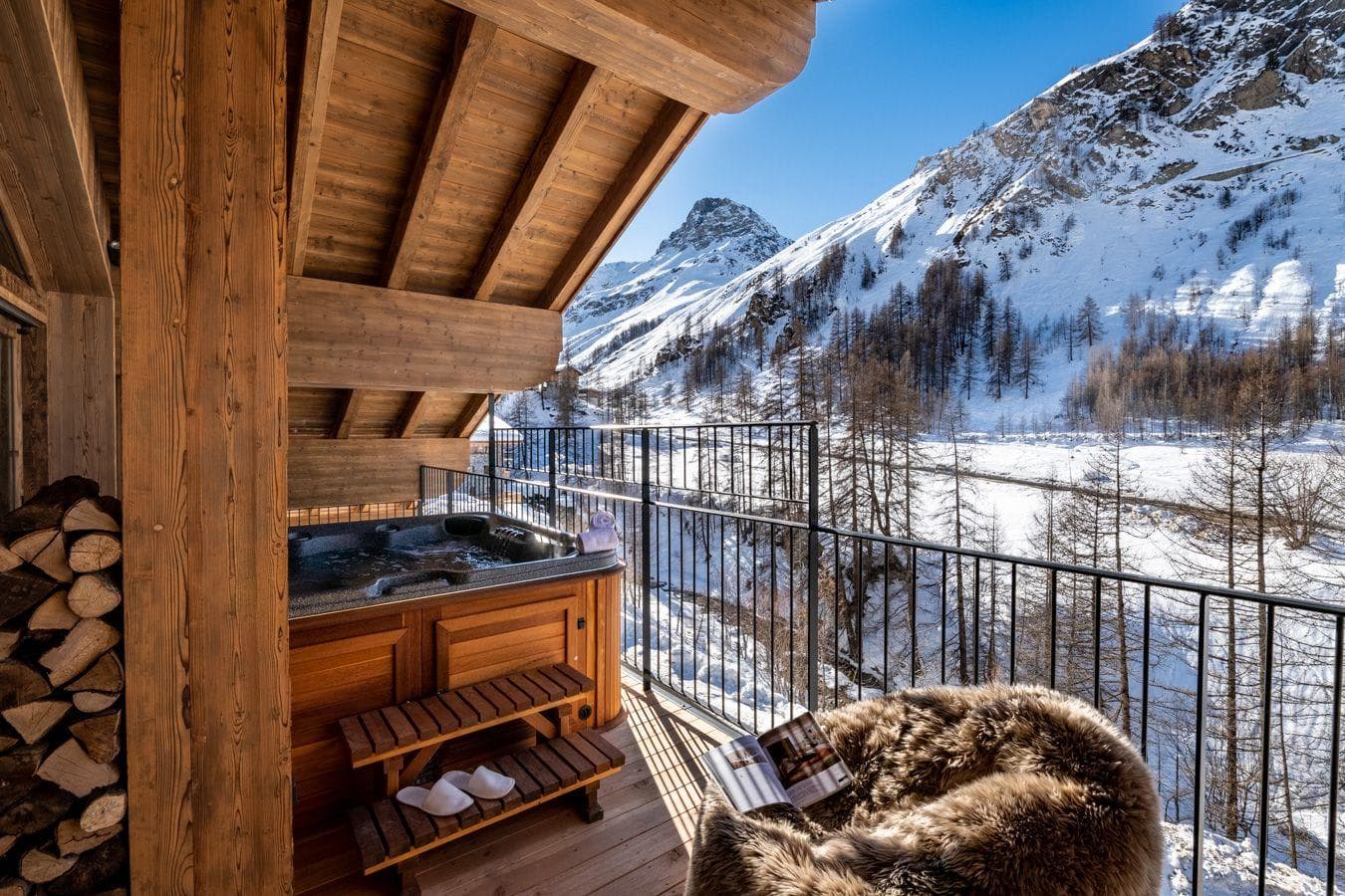 Covered balcony with private hot tub and mountain valley views