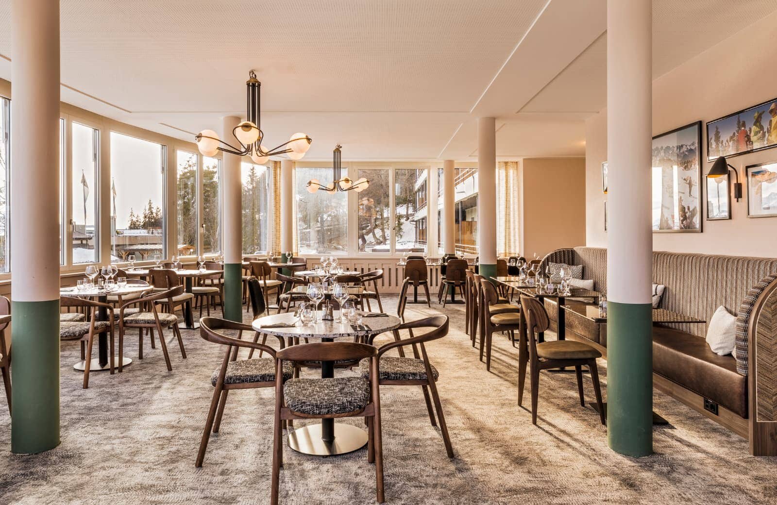 Dining area with booth seating and floor-to-ceiling windows showing snow-covered grounds