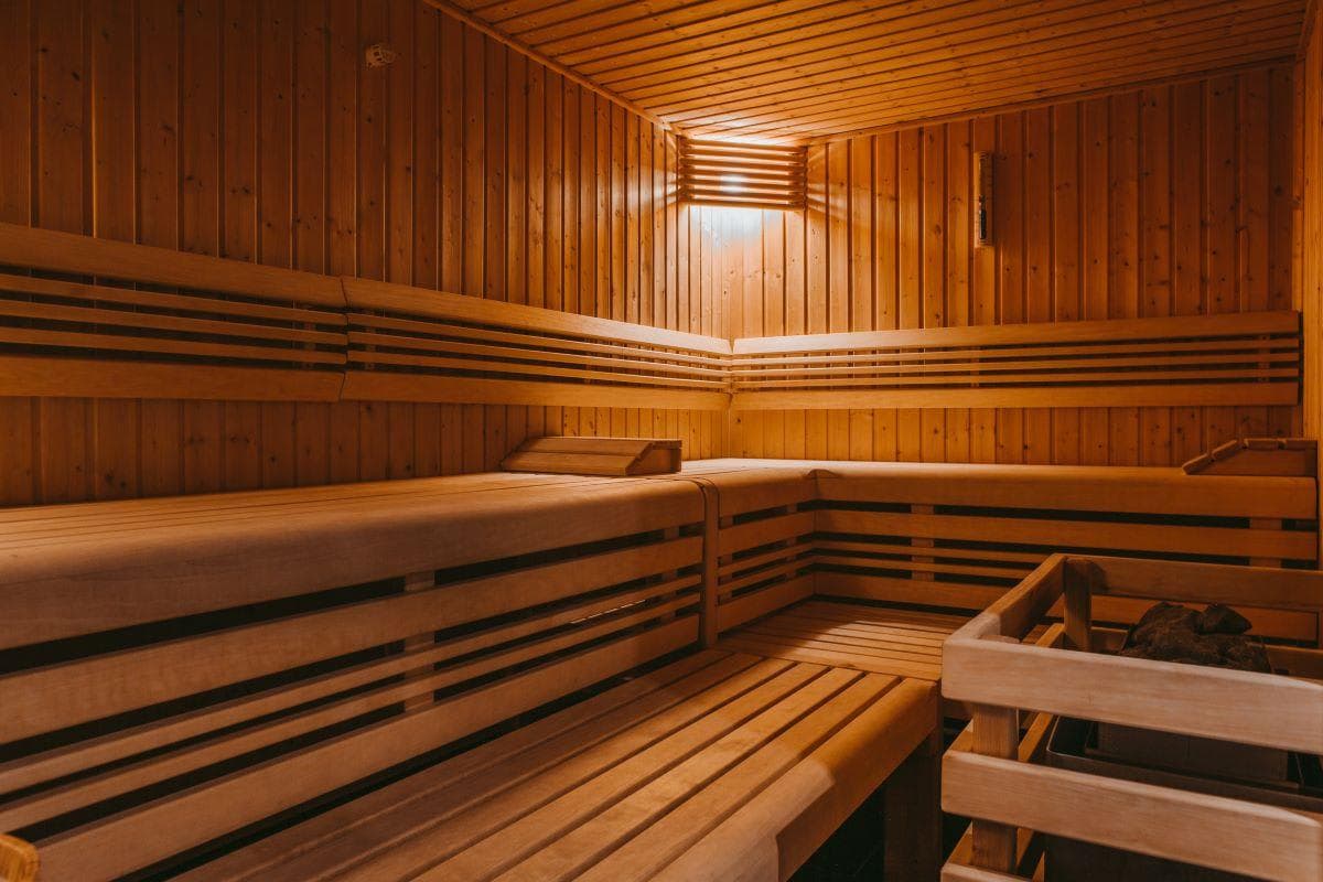 Wood sauna with two-tiered seating and electric rock heater