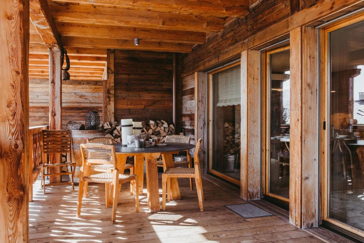 Covered balcony with circular dining table and seating for 6