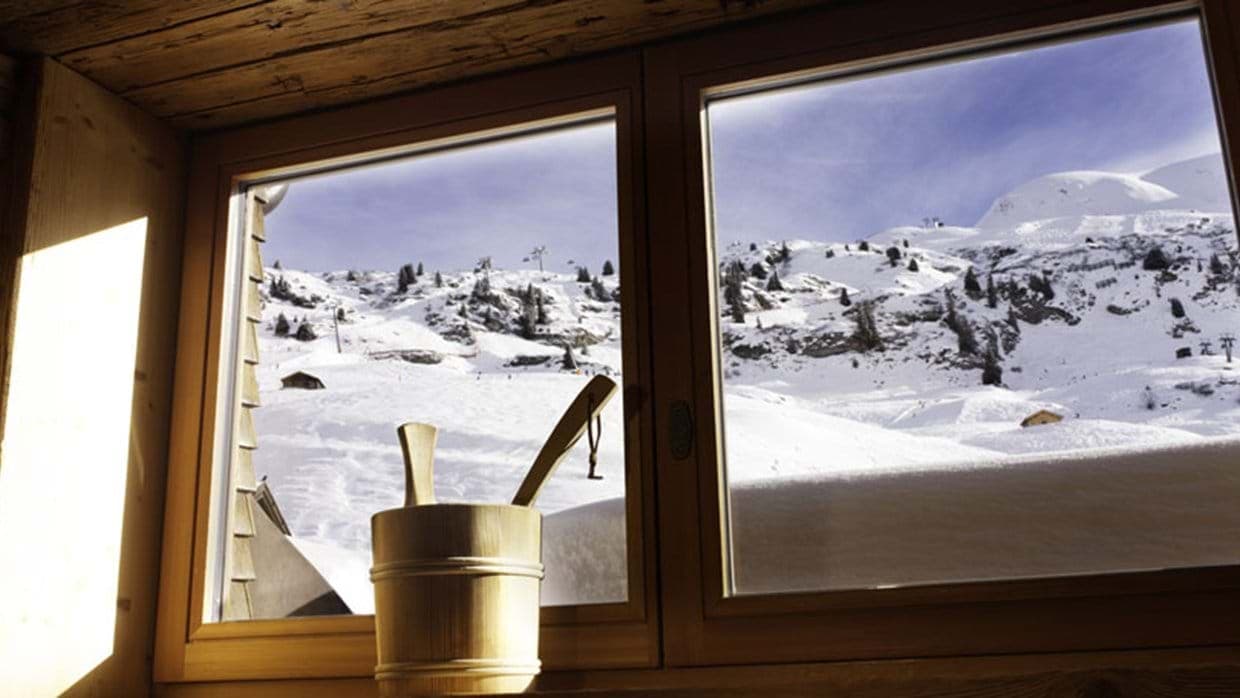 Sauna with mountain view overlooking active ski lifts