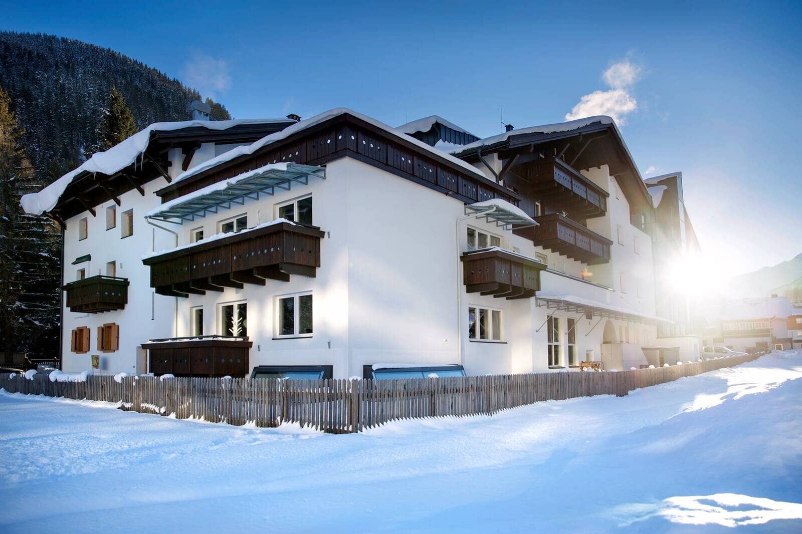 Chalet exterior with private balconies and snow-covered yard