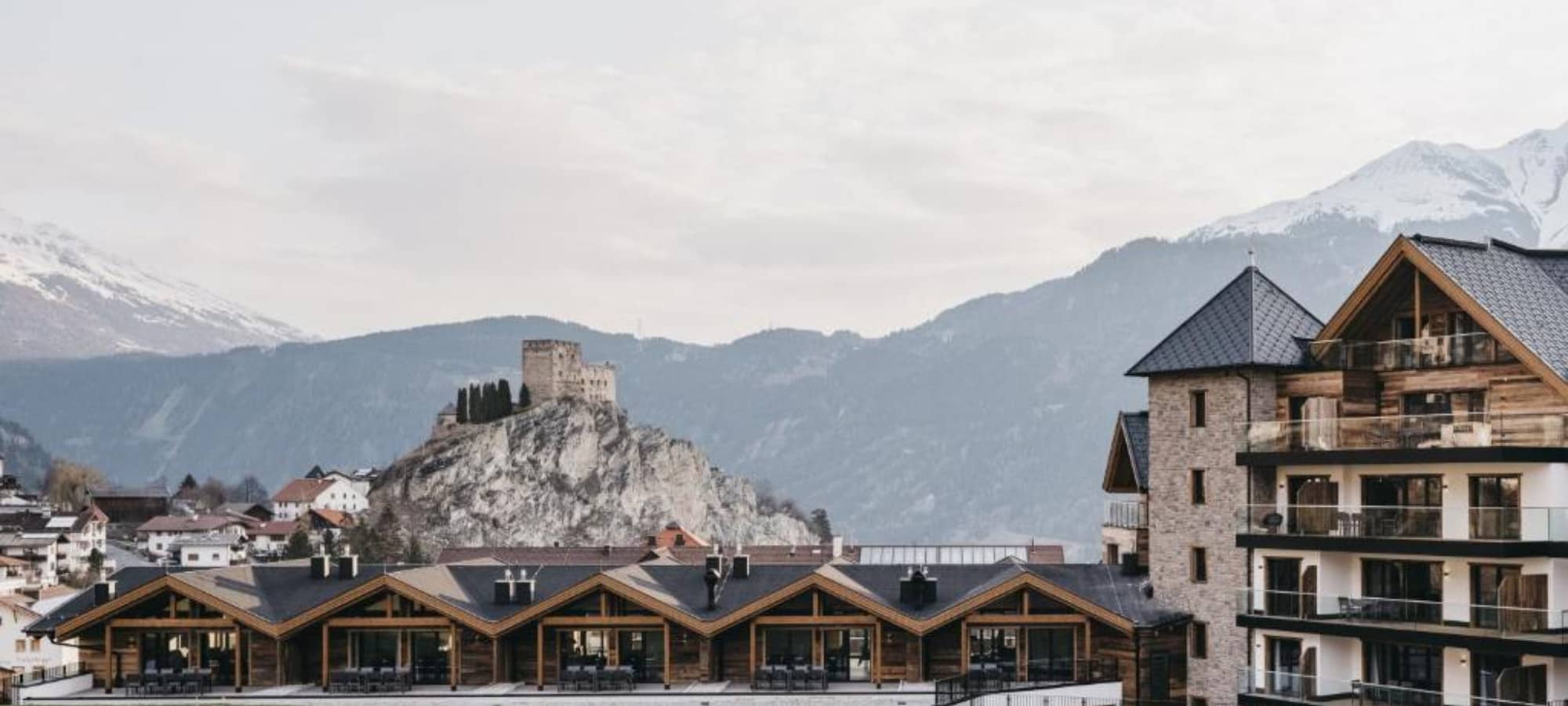 Building exterior featuring private balconies with castle and mountain views