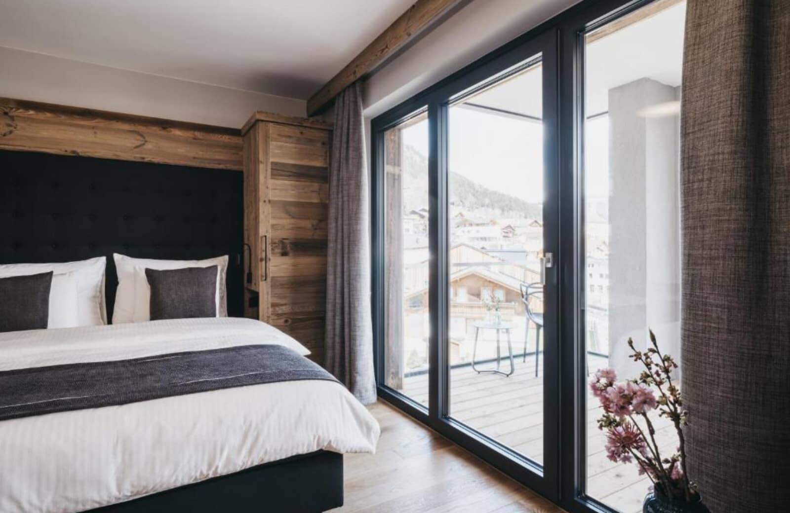 Bedroom with sliding glass doors opening to a private mountain-view balcony