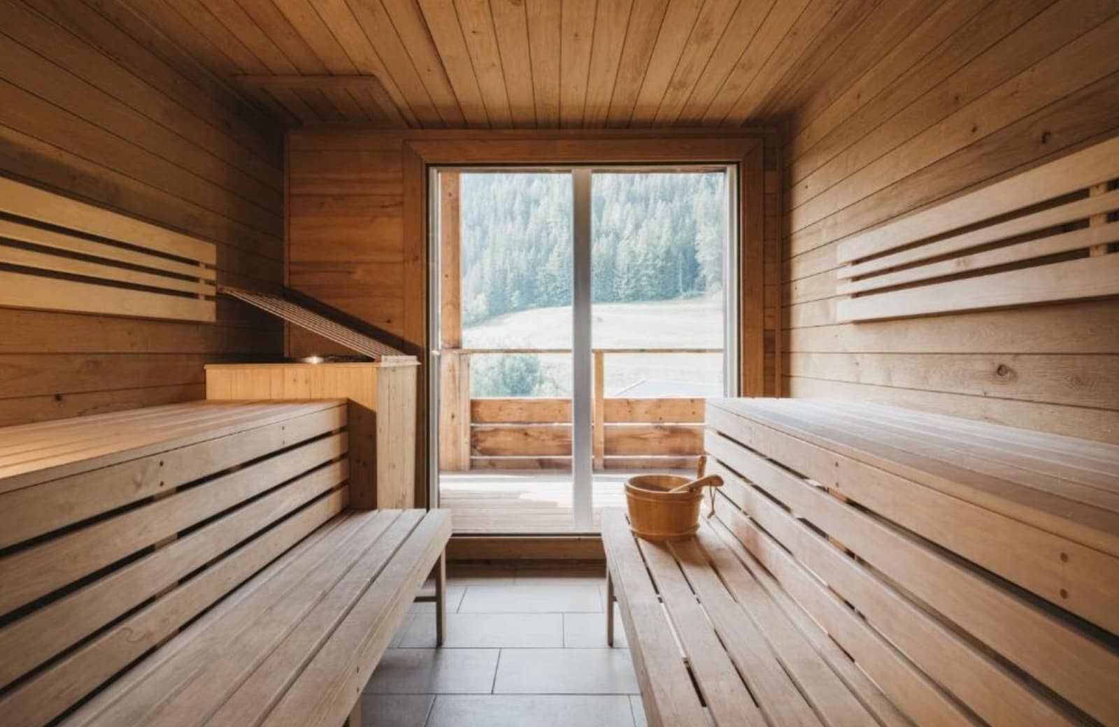 Sauna with tiered seating and scenic forest views