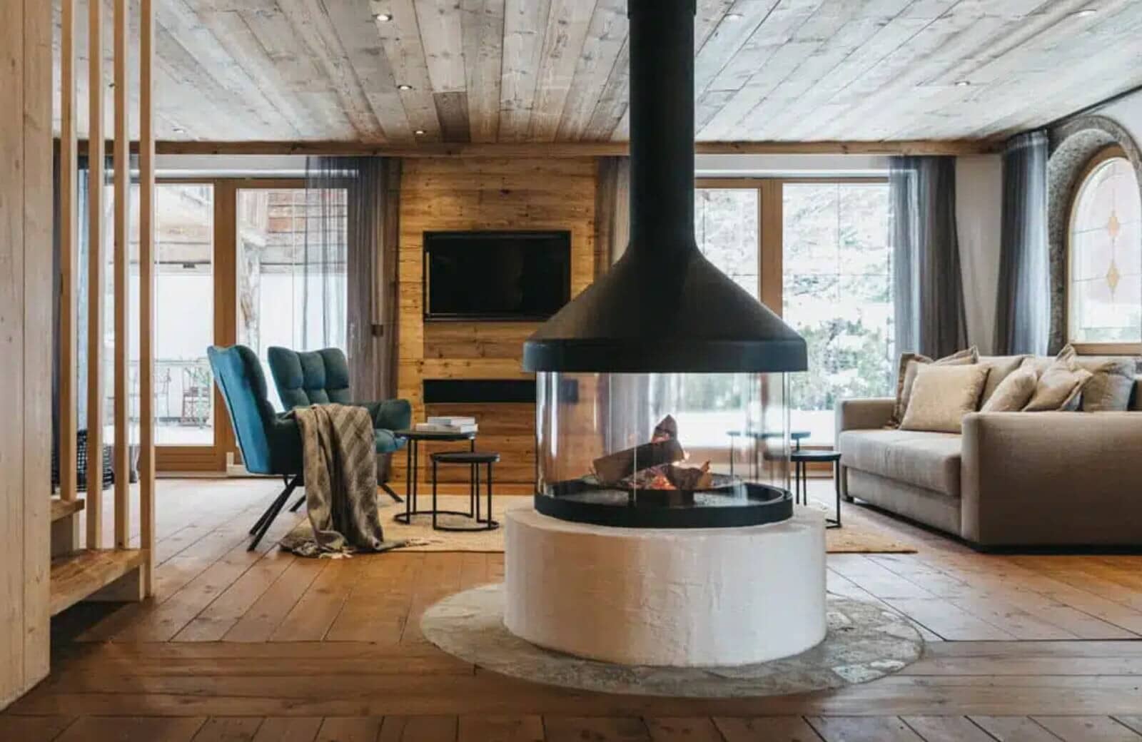 Living area featuring central 360-degree glass fireplace and wood-paneled walls