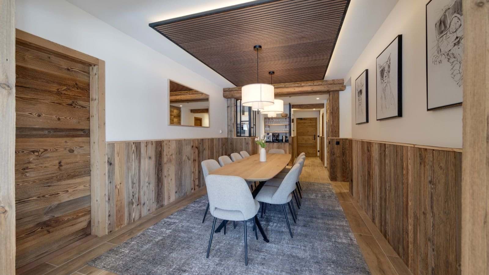 Dining area seating 8 with reclaimed wood paneling and coffee station