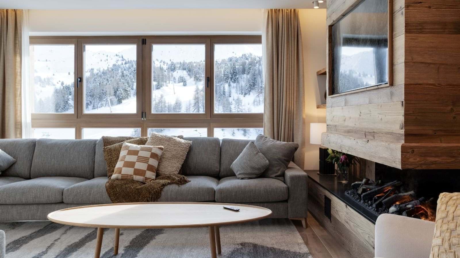 Living area with wood-burning fireplace and mountain-view windows