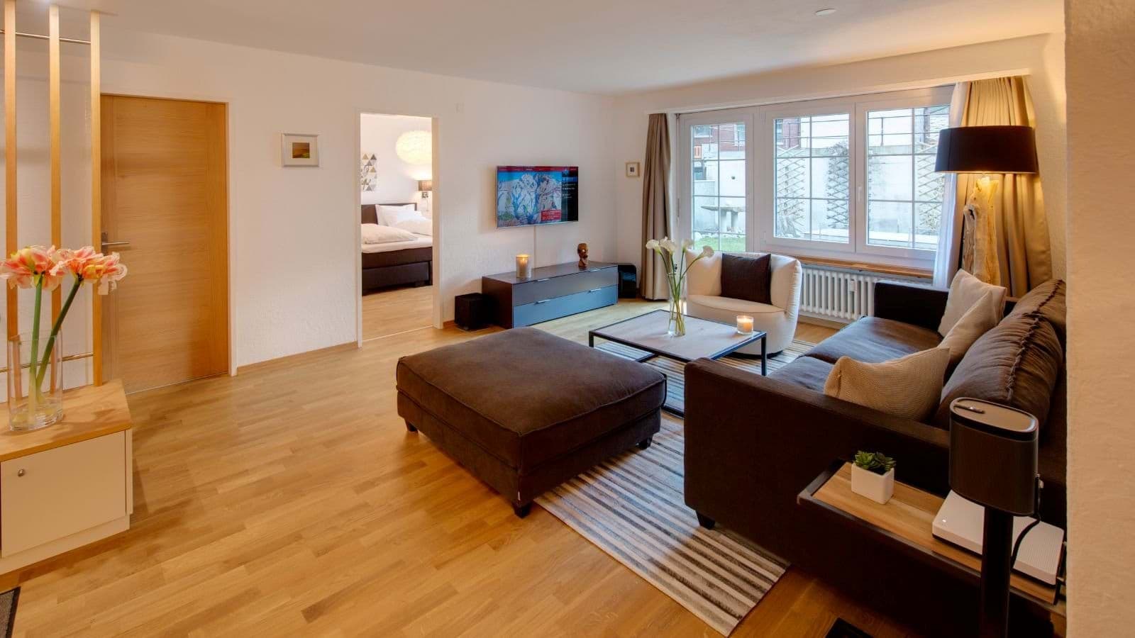 Living area with Smart TV, sound system, and hardwood flooring throughout