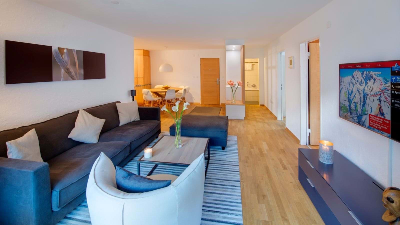 Open-plan living area with smart TV and dining seating for 4