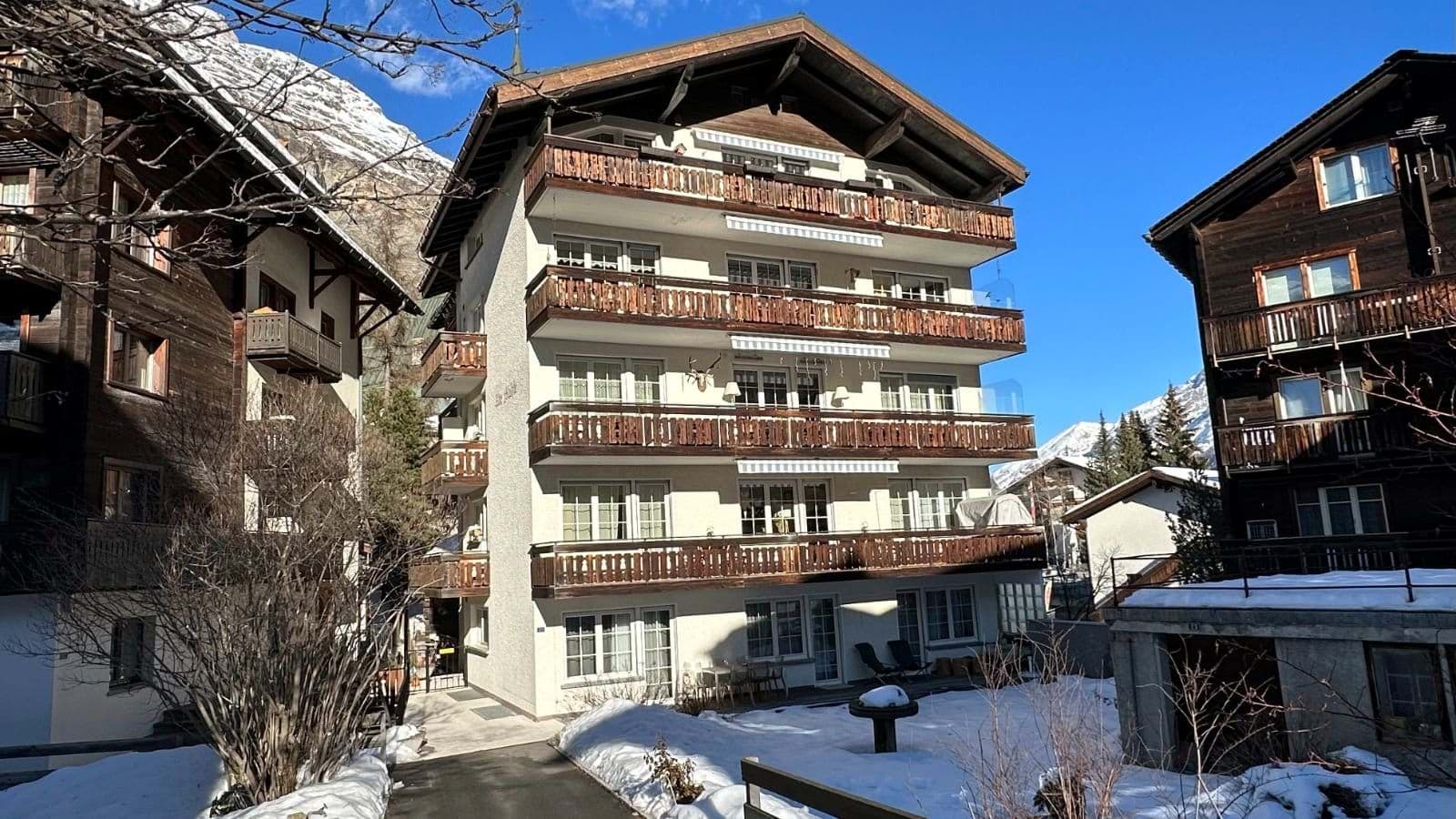 Chalet exterior with multiple private balconies and mountain views
