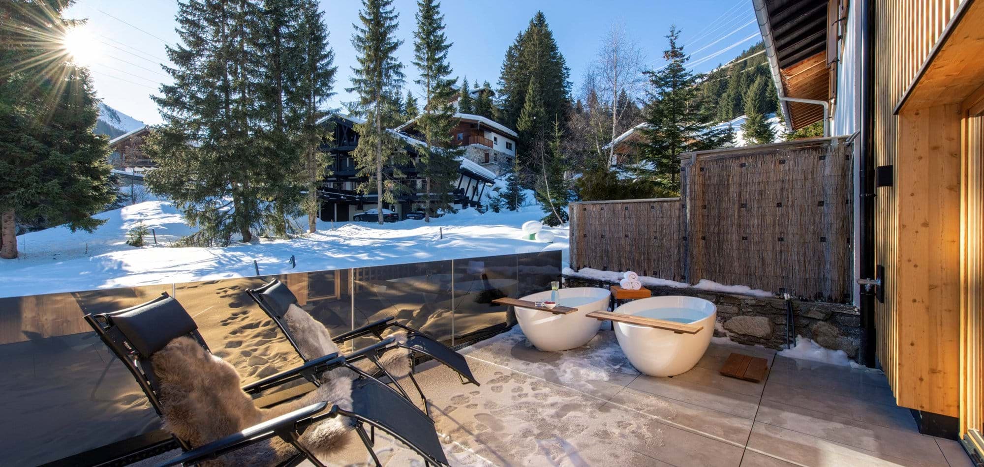 Private sun terrace with twin soaking tubs and mountain views