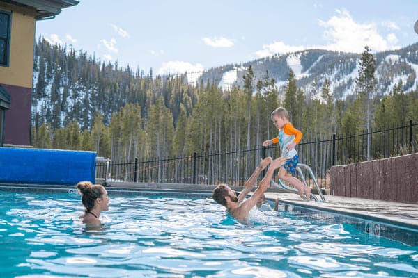Shared outdoor heated pool with ski slope views