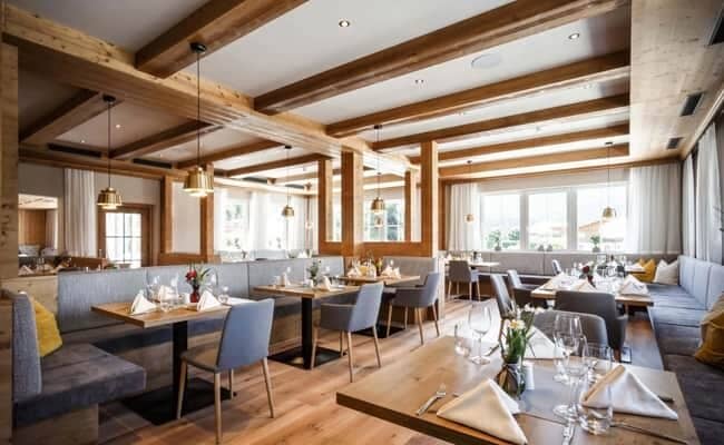 Dining area with booth seating and integrated ceiling speakers