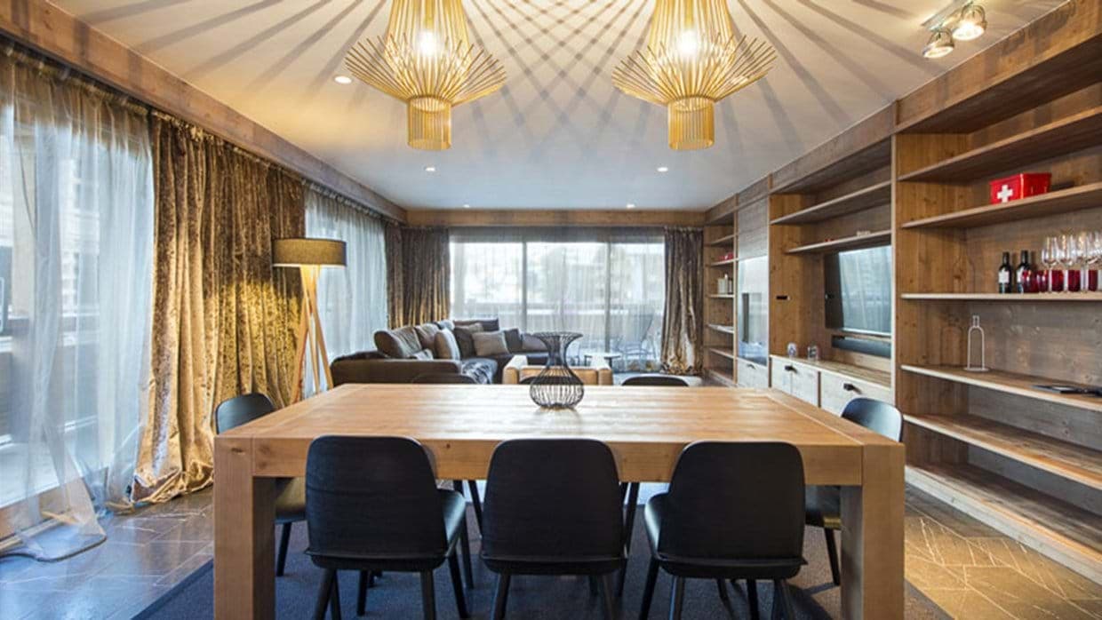 Open-concept dining area seating 8; floor-to-ceiling windows and balcony access