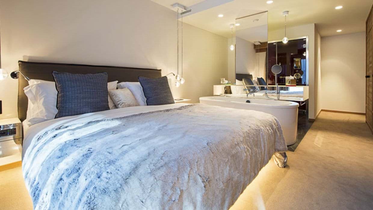 Primary bedroom with king bed and open-concept soaking tub