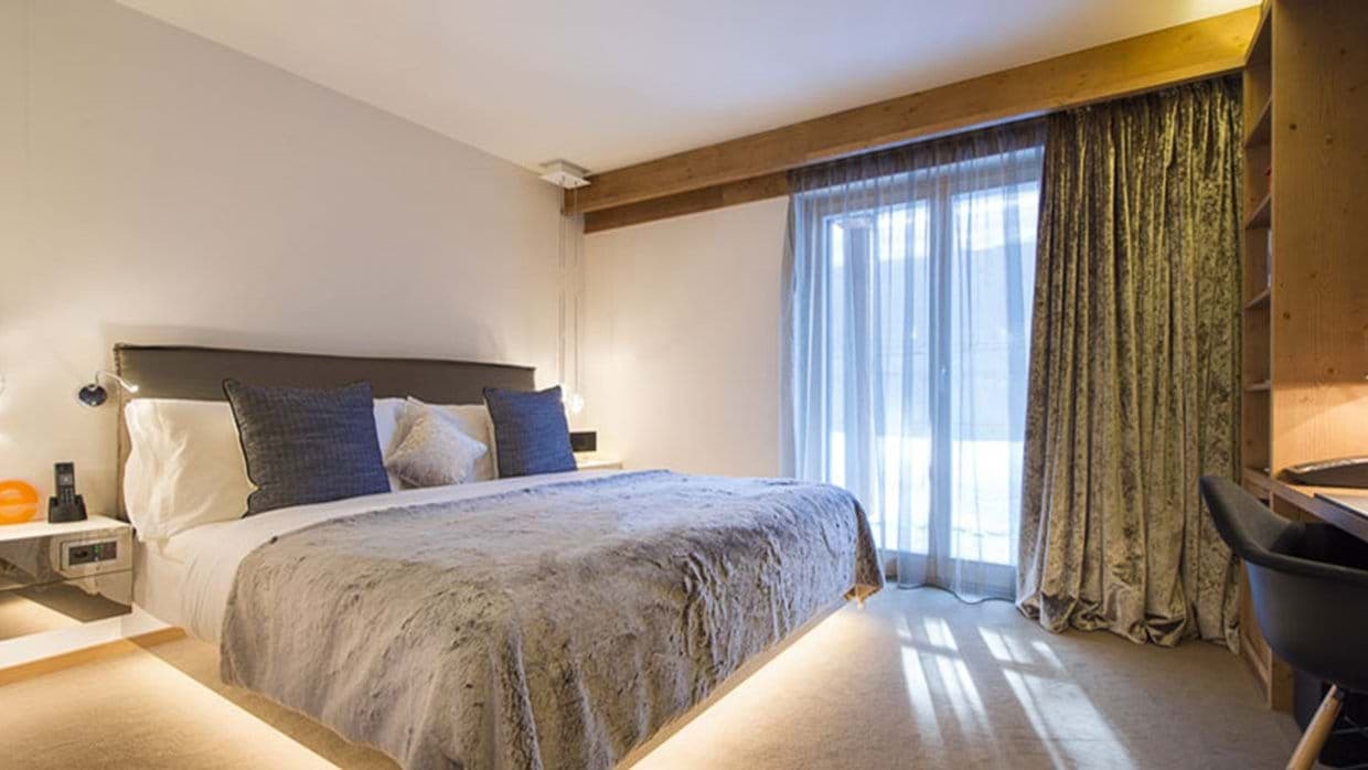 Primary bedroom with king bed and built-in desk workstation