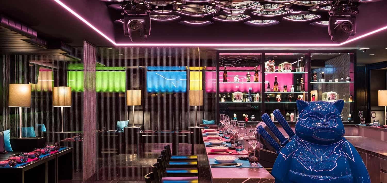 Private sushi bar and lounge with neon lighting and counter seating