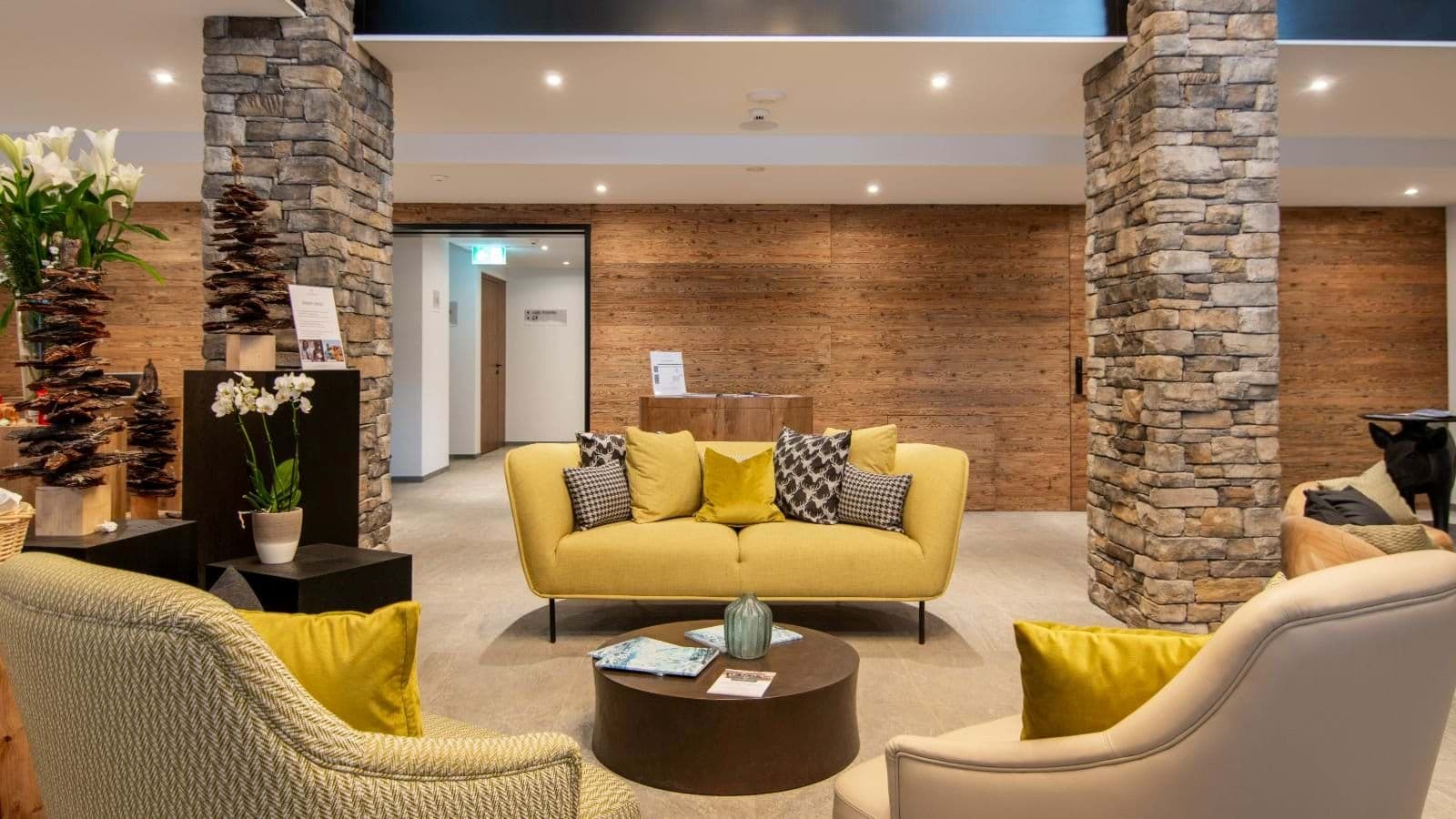 Shared lounge area with stone pillars and wood paneling