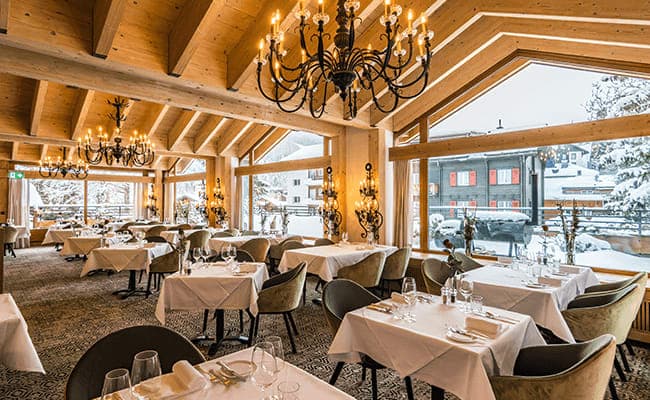 Dining room with vaulted timber ceilings and village views