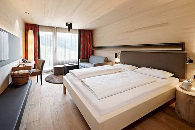 Bedroom with king bed, dedicated workspace, and sofa seating