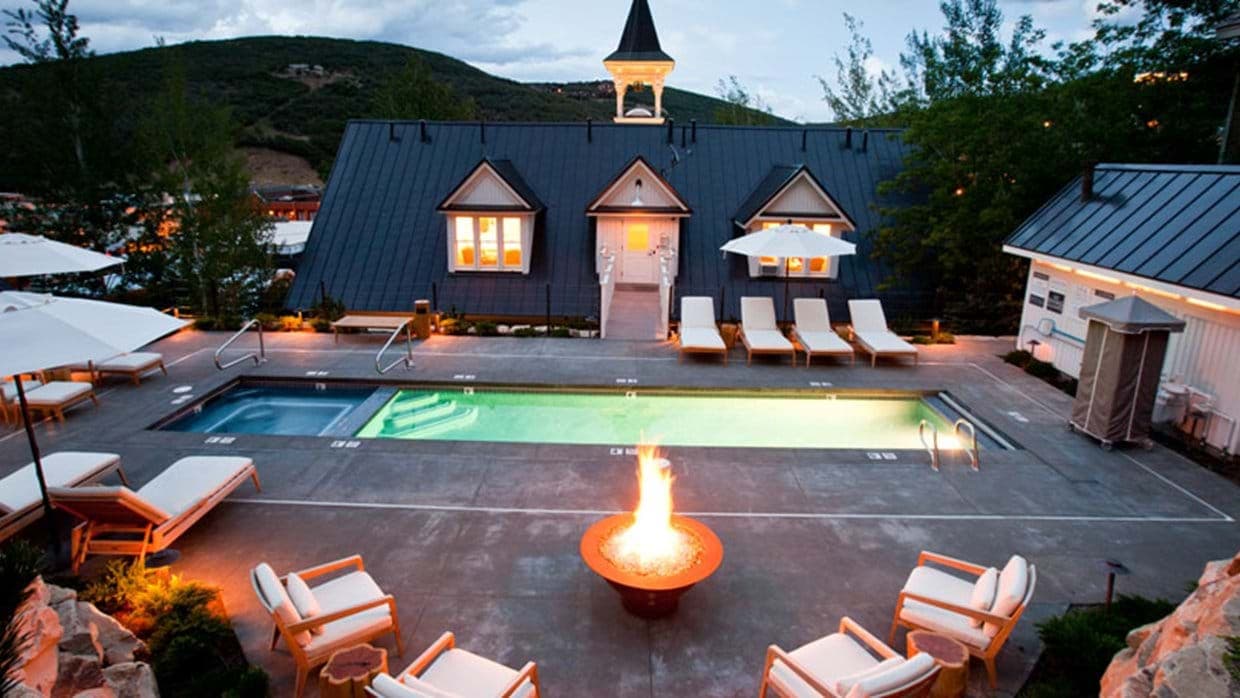 Shared pool and hot tub area with gas fire pit and mountain views