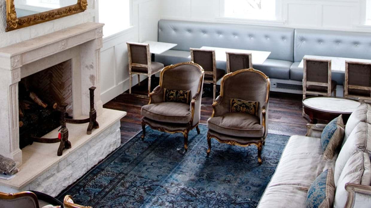 Sitting area with wood-burning fireplace and café-style banquette seating