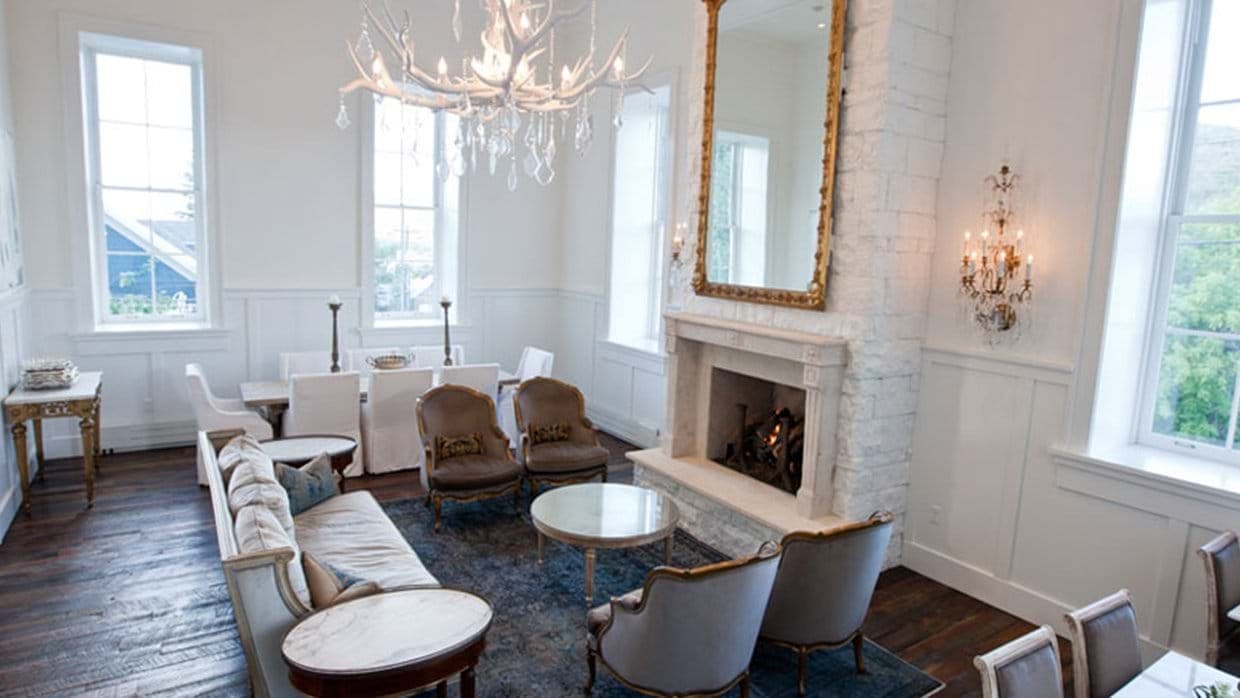 Living area with wood-burning fireplace and dining table seating 6