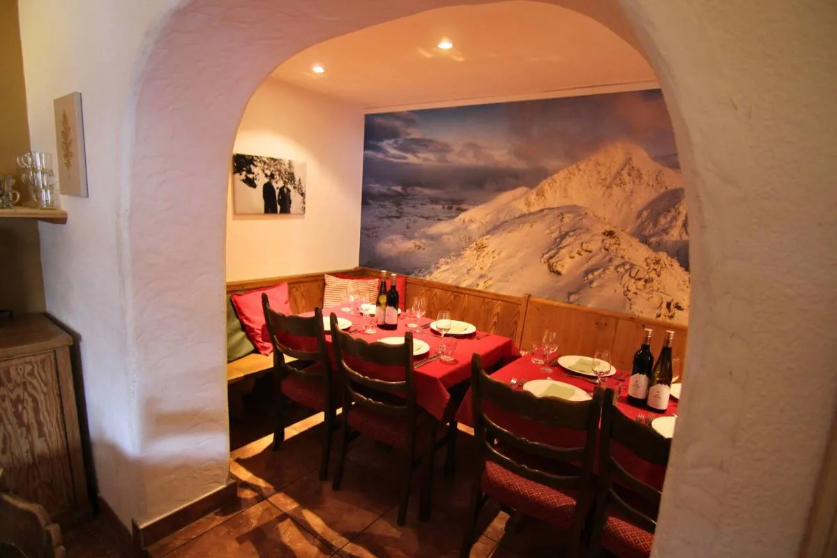 Dining tables beside a mountain mural