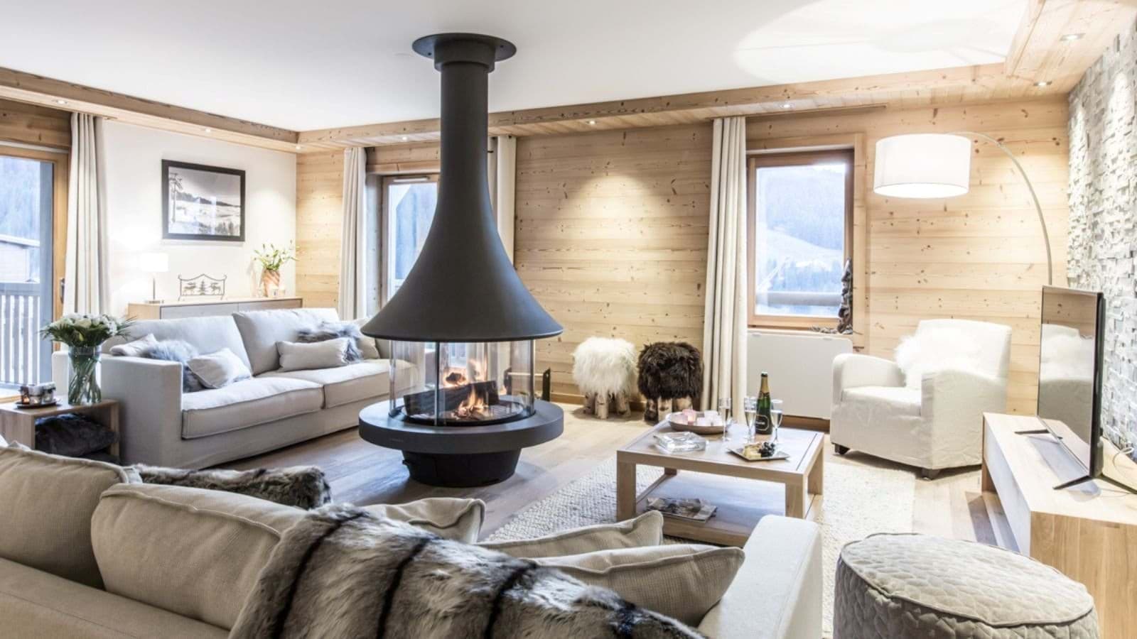 Living area with 360-degree central fireplace and balcony access