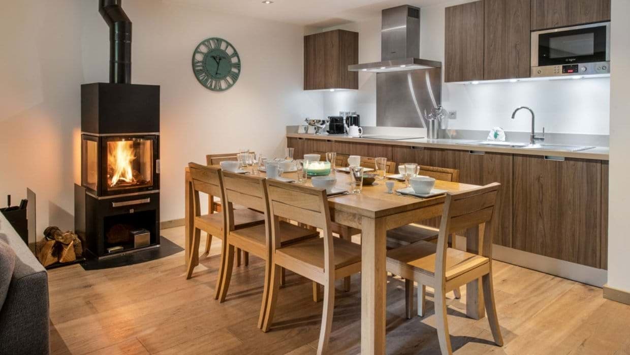 Open-plan dining area with wood-burning stove and seating for 8