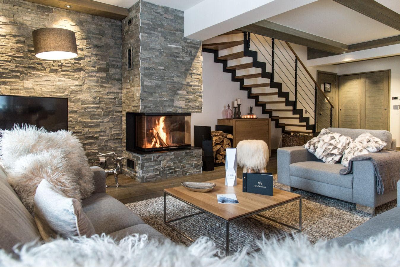 Living area with wood-burning fireplace and stone feature wall